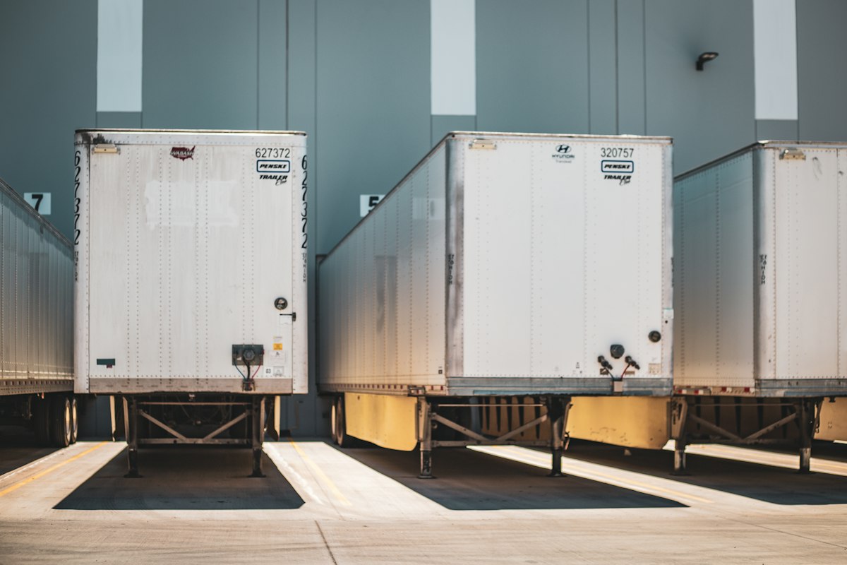 A row of semi trucks parked together